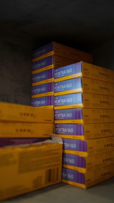 Stacked boxes with colorful packaging, arranged neatly in a storage area.